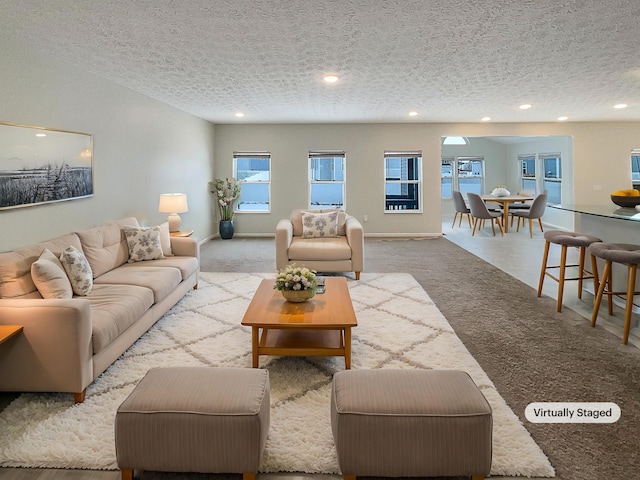 1128 Legacy Ln, Pataskala, OH 43062 - carpeted living area featuring a textured ceiling and recessed lighting