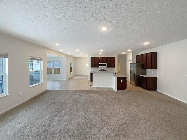 1128 Legacy Ln, Pataskala, OH 43062 - unfurnished living room featuring light colored carpet, recessed lighting, and a textured ceiling