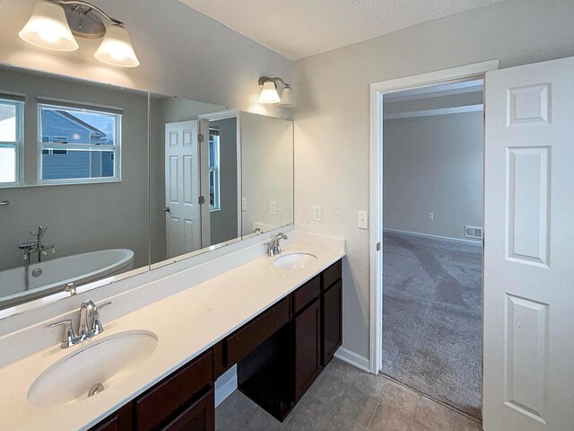 1128 Legacy Ln, Pataskala, OH 43062 - full bathroom featuring a freestanding tub, double vanity, and tile patterned floors