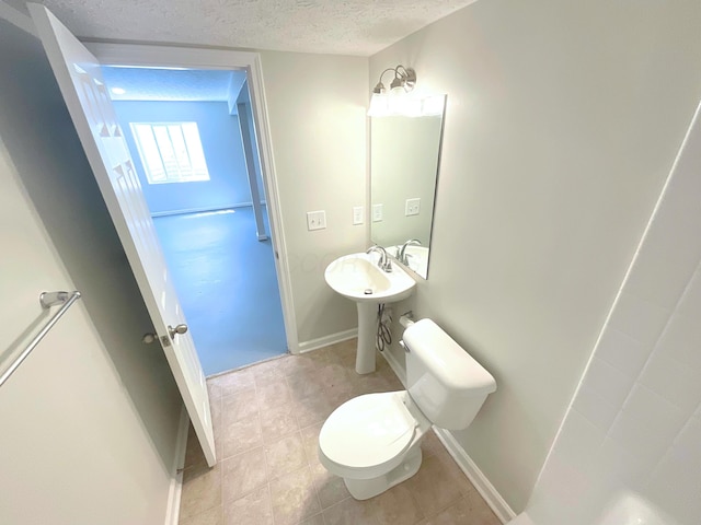 1128 Legacy Ln, Pataskala, OH 43062 - bathroom featuring a textured ceiling and tile patterned flooring