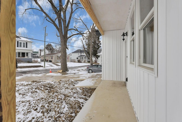 yard layered in snow with a residential view