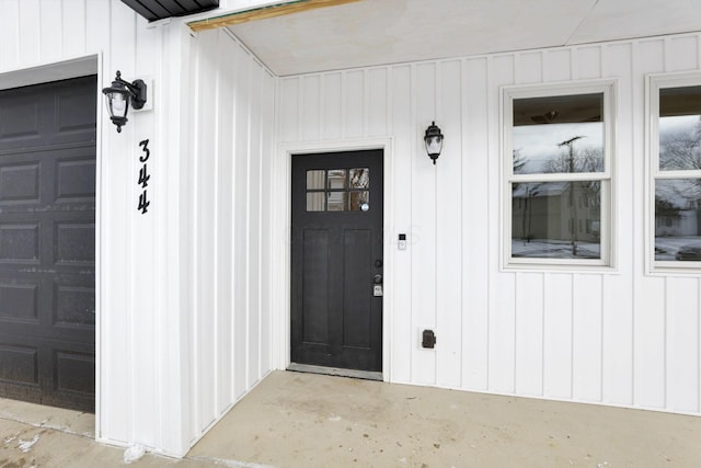 view of exterior entry with a garage