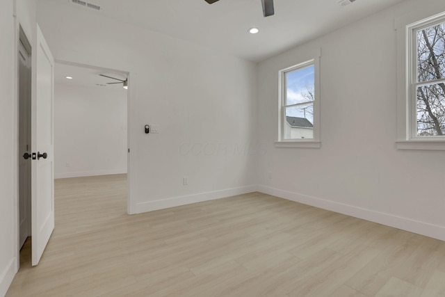 unfurnished room with light wood-style floors, plenty of natural light, and ceiling fan