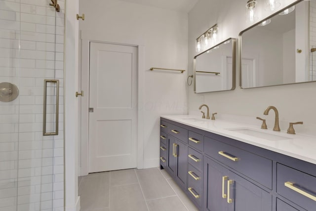 full bath with tile patterned flooring, a sink, a tile shower, and double vanity