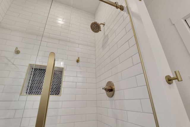 bathroom with a tile shower