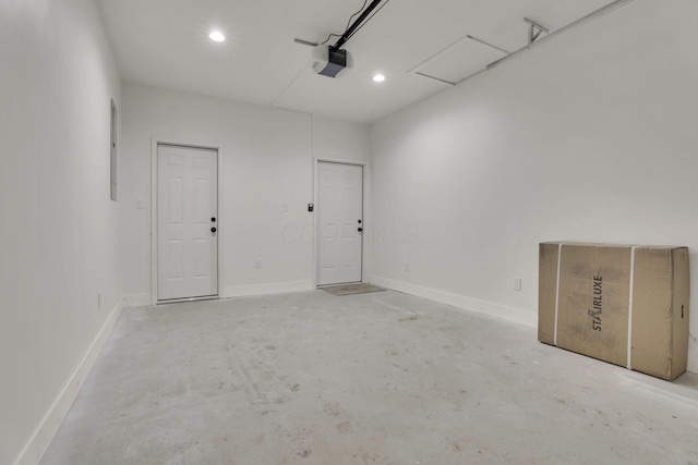 garage featuring a garage door opener, recessed lighting, and baseboards