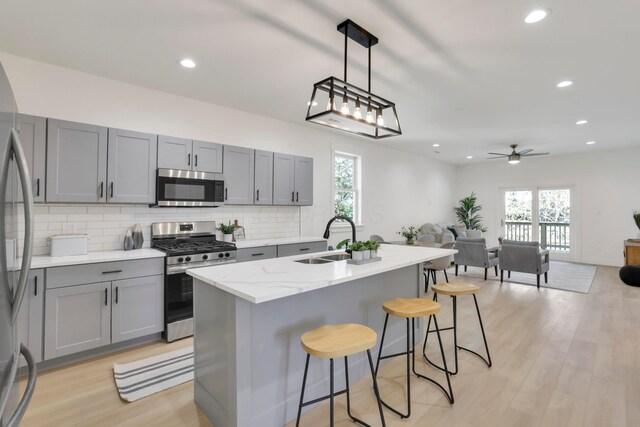 344 Buckingham St, Newark, OH 43055 - kitchen featuring appliances with stainless steel finishes, a sink, gray cabinets, tasteful backsplash, and open floor plan