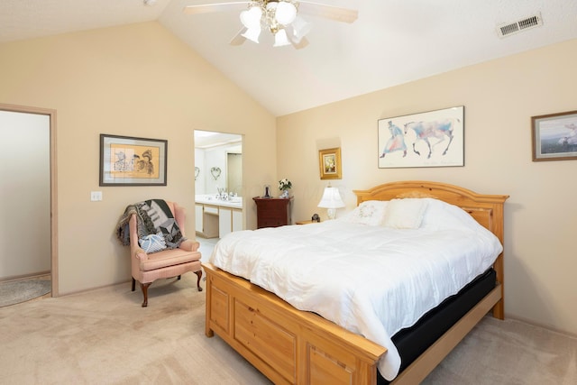 bedroom with light colored carpet, visible vents, connected bathroom, vaulted ceiling, and ceiling fan