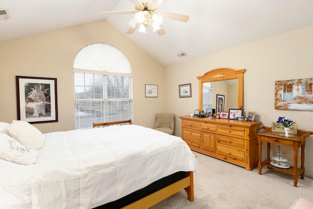 bedroom featuring vaulted ceiling, visible vents, a ceiling fan, and light colored carpet