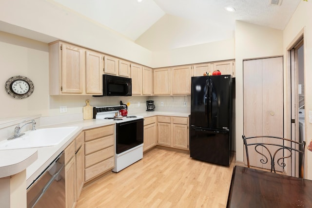 kitchen with lofted ceiling, light wood-type flooring, black appliances, light brown cabinets, and a sink