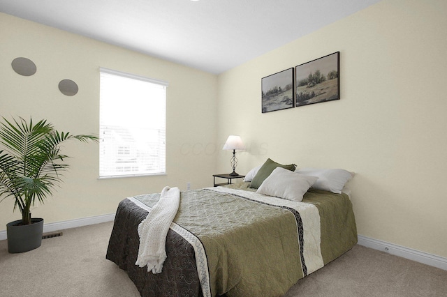 bedroom featuring light colored carpet, visible vents, and baseboards