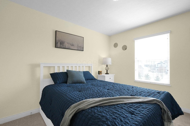 bedroom with carpet floors and baseboards