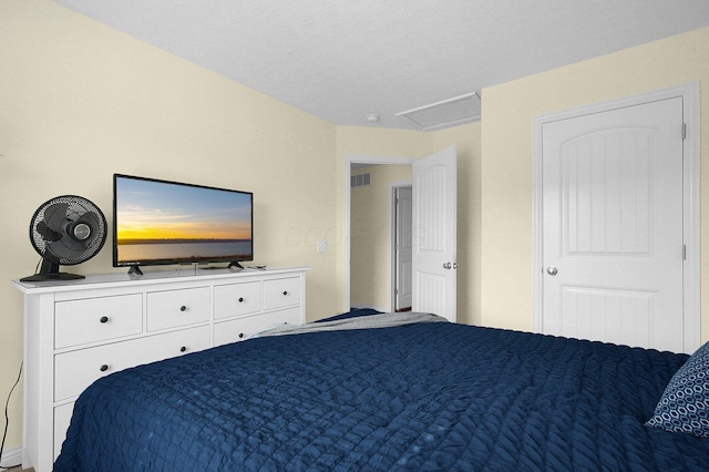 bedroom featuring visible vents and attic access