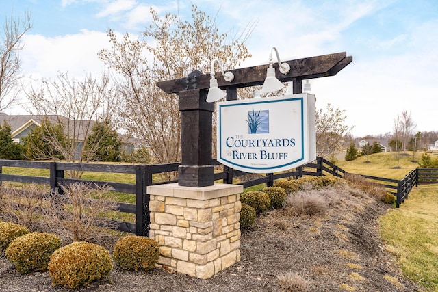 community / neighborhood sign with fence