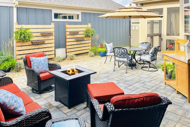 view of patio featuring outdoor dining area and an outdoor living space with a fire pit