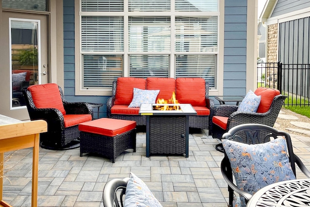 view of patio with an outdoor living space with a fire pit