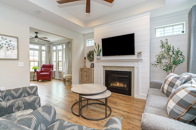 living area featuring visible vents, light wood-style flooring, and plenty of natural light