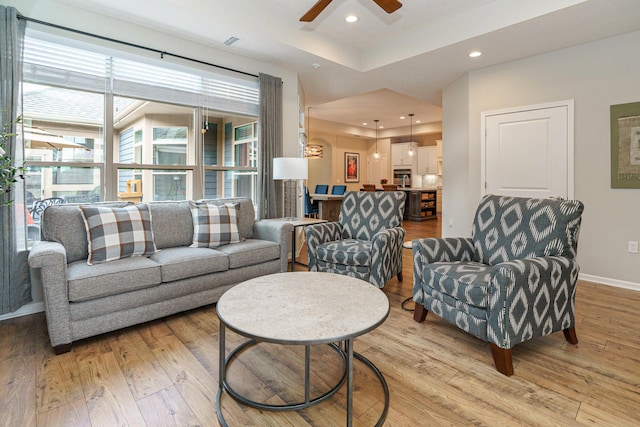 living area with visible vents, baseboards, recessed lighting, light wood-style flooring, and a ceiling fan