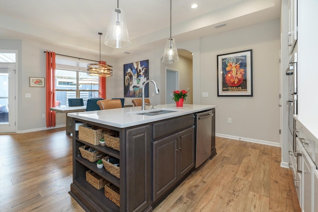 kitchen with dishwasher, open shelves, light countertops, and a sink