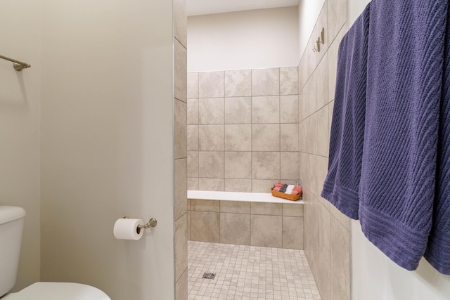 full bathroom with toilet and a tile shower