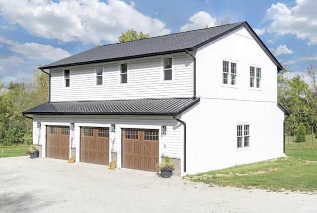 view of home's exterior with metal roof, a standing seam roof, and an attached garage