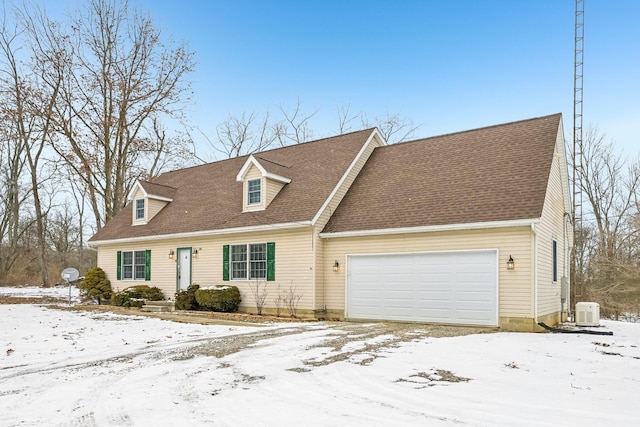 cape cod house with a garage, central AC, and a shingled roof