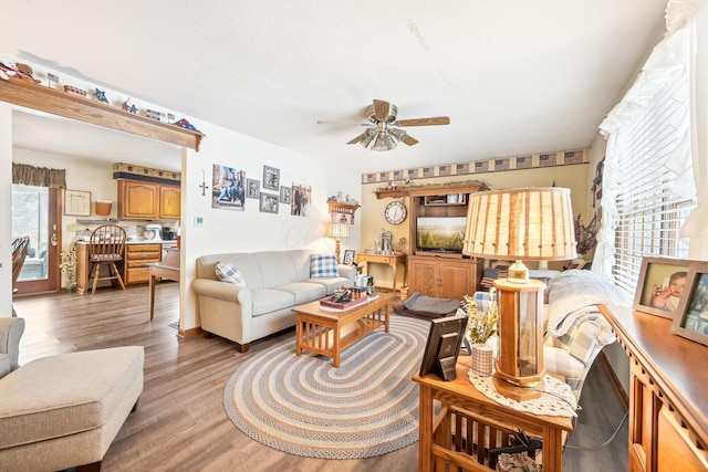 living area with light wood-style floors and a ceiling fan