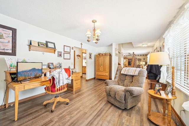 home office with a notable chandelier, baseboards, and wood finished floors