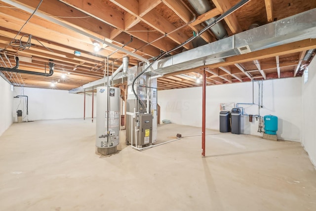 unfinished basement featuring heating unit and gas water heater