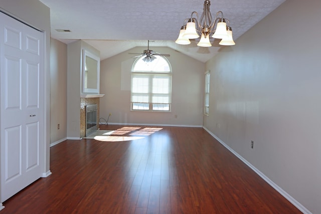 unfurnished living room featuring a fireplace, visible vents, vaulted ceiling, a textured ceiling, and wood finished floors