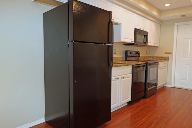 kitchen featuring dark wood-style floors, black appliances, white cabinetry, and baseboards