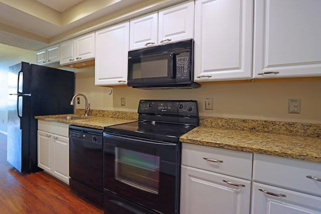 kitchen featuring black appliances, white cabinetry, dark wood finished floors, and a sink