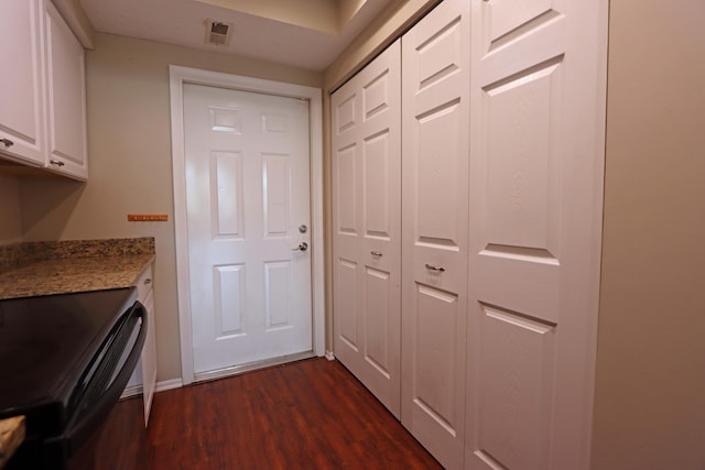 doorway featuring visible vents and dark wood-style flooring