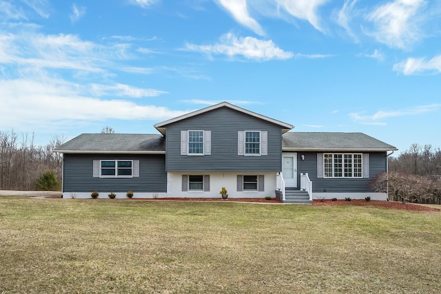 tri-level home with a front yard and brick siding