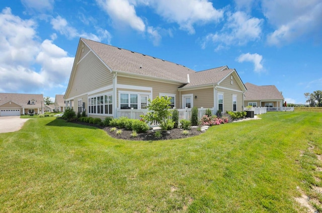 614 Newport Ln, Hebron, OH 43025 - back of house featuring a yard, central AC unit, and a shingled roof