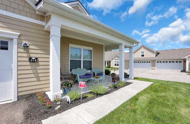 614 Newport Ln, Hebron, OH 43025 - property entrance with covered porch, concrete driveway, and a yard
