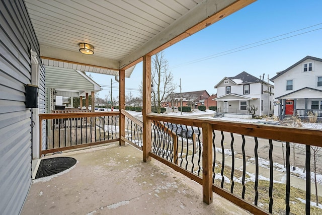 balcony featuring covered porch and a residential view