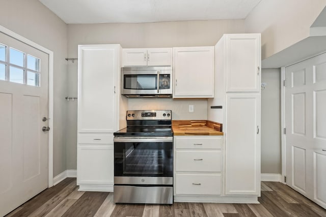 kitchen with white cabinets, stainless steel appliances, and wood finished floors