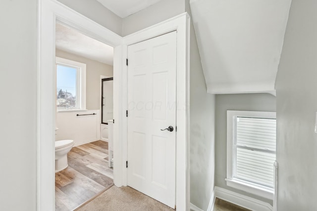 interior space featuring wood finished floors, toilet, and baseboards