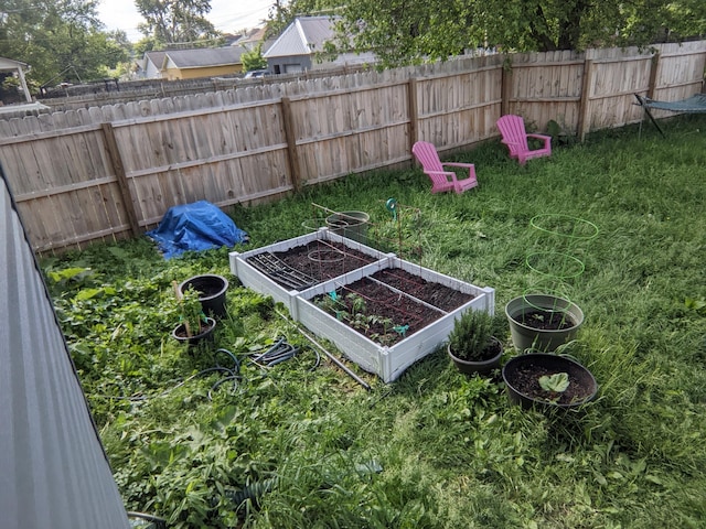 view of yard featuring fence and a garden