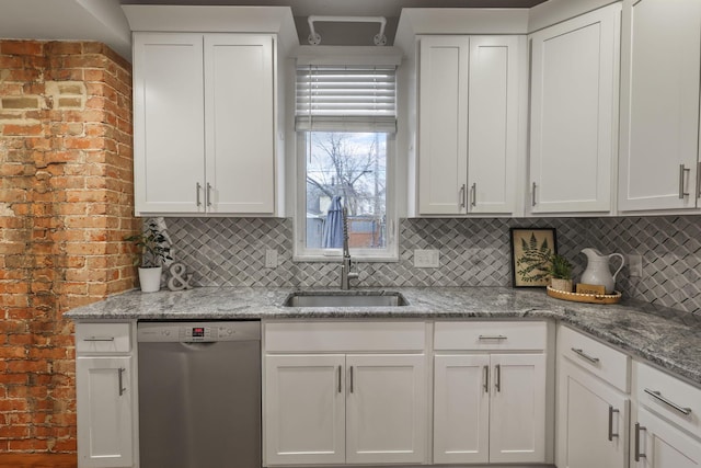 kitchen featuring white cabinets, dishwasher, backsplash, and a sink