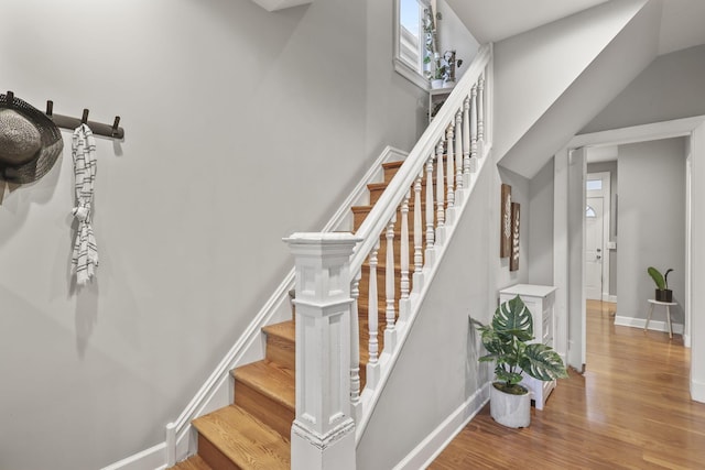 stairway featuring baseboards and wood finished floors