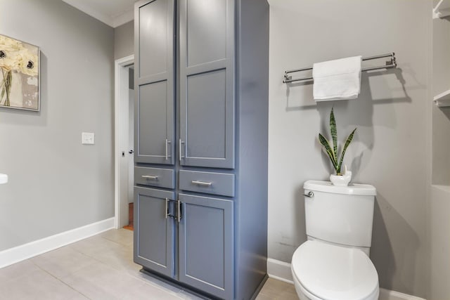 bathroom featuring toilet, baseboards, and tile patterned floors