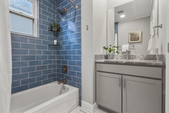 full bathroom with visible vents, baseboards, shower / tub combo with curtain, and vanity