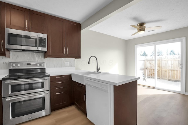 kitchen with visible vents, ceiling fan, light countertops, a peninsula, and stainless steel appliances