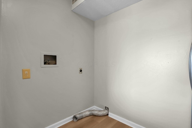 laundry room featuring hookup for a washing machine, wood finished floors, baseboards, laundry area, and electric dryer hookup