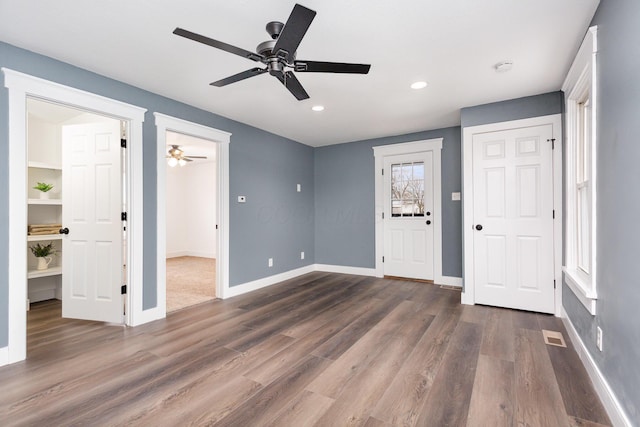 interior space featuring dark wood-style floors, recessed lighting, and baseboards