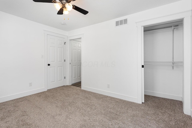 unfurnished bedroom featuring carpet floors, baseboards, visible vents, and a closet