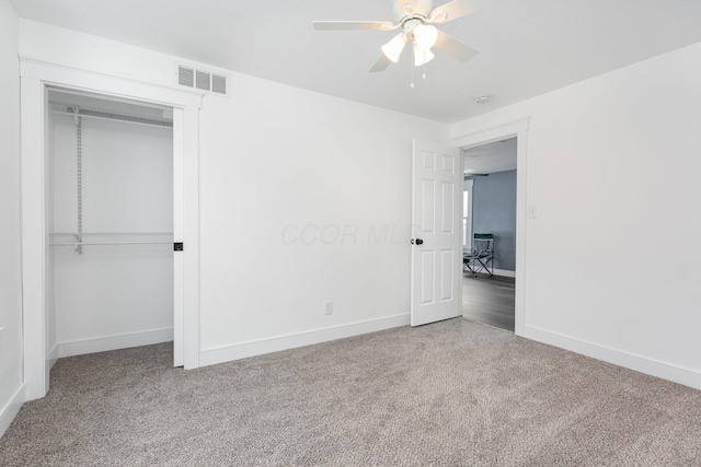 unfurnished bedroom with carpet floors, baseboards, visible vents, and a closet