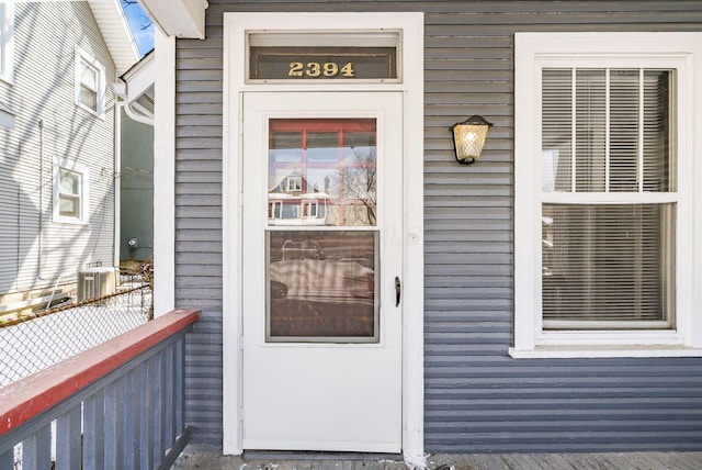 property entrance featuring central AC unit